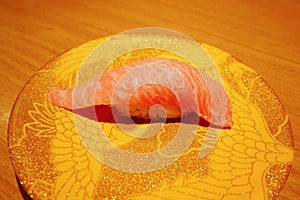 Close up of otoro tuna sushi nigiri on plate in sushi belt japan restaurant.