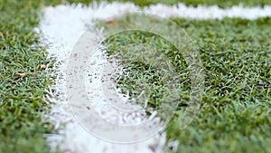 Close up of the out of bounds line on a turf