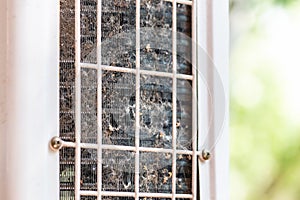 Close-up outdoor air condition unit with clogged obstructed compressor radiator grill. Details of air conditioner needed photo