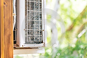 Close-up outdoor air condition unit with clogged obstructed compressor radiator grill. Details of air conditioner needed to clean