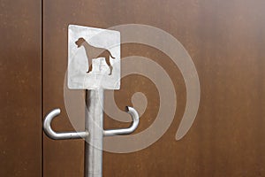 Close-up of an outdoor dog parking sign. A place for a leash for dogs waiting for their owners on the street. Attach a leash, in