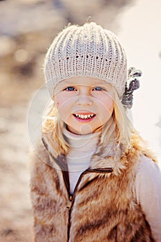 Close up outdoor portrait of beautiful child girl looking at camera