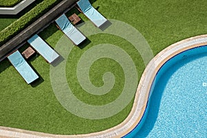 Close up outdoor swimming pool and pool chairs with clear clean