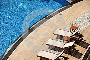 Close up outdoor swimming pool and pool chairs with clear clean