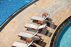 Close up outdoor swimming pool and pool chairs with clear clean
