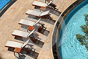 Close up outdoor swimming pool and pool chairs with clear clean