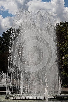 Close up outdoor view in the night of a public fountain with many small water jets. Abstract natural image with pattern