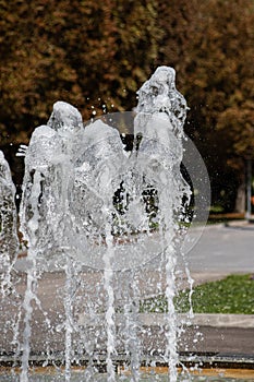 Close up outdoor view in the night of a public fountain with many small water jets. Abstract natural image with pattern