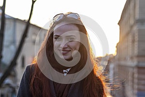 Close-up outdoors lifestyle portrait of happy smiling young woman.