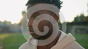 Close up outdoors portrait tired African American young man male sportsman looking down hard breath fatigue after