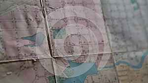 Close-up of outline map details. Stock footage. Details of marked area on contour map. Old contour map with markers and