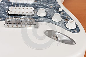Close up output connector on white electric guitar, studio shoot