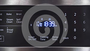 Close up of oven display flickering, control panel blinking. Electricity problem photo