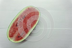 Close Up over head of fresh watermelon fruit cut slice red Dissect isolated on wood table white background