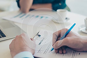 Close up overhead above top photo of man`s hands signing a contract contract business partnership real estate agent recruiter con