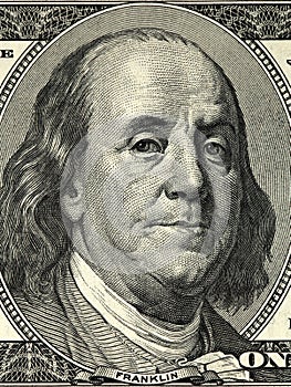 Close up overhead view of Benjamin Franklin face on 100 US dollar bill. US one hundred dollar bill closeup