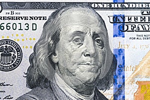Close up overhead view of Benjamin Franklin face on 100 US dollar bill. US one hundred dollar bill closeup. Heap of one hundred do