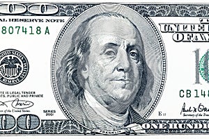 Close up overhead view of Benjamin Franklin face on 100 US dollar bill. US one hundred dollar bill closeup. Heap of one hundred