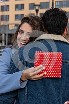 Close up overjoyed wife hugging husband, thanking for romantic present, surprise, happy attractive young woman holding gift box ,