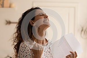 Close up overjoyed woman rejoicing success, holding letter, received news