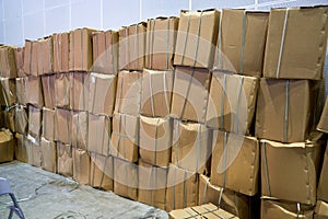 Close-up of packed cartons piled up in warehouse photo