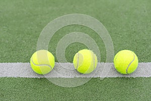 close up of a padel and tennis court with artificial grass and balls