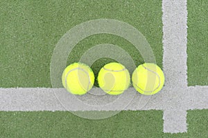 close up of a padel and tennis court with artificial grass and balls