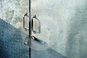 Close up Padlock with old iron gate background.