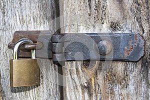 Close up of padlock and old metal hasp and staple