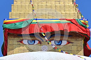 Close up of painted Eyes of Buddha on the harmika or square tower of main stupa at Boudhanath, Kathmandu