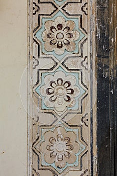 Close up of the painted floral motifs at the entrance of the Qutub Shahi Tombs in Hyderbad, Telangana, India