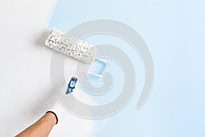 Close up of painter hand painting a wall