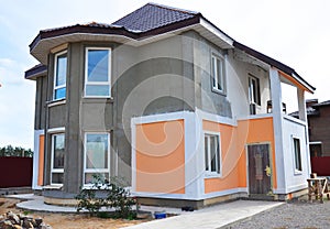 Close up on Painting and Plastering Exterior House Wall. Facade Thermal Insulation and Painting Works