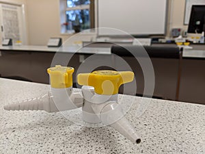 A close up of a pair of gas taps on a laboratory work bench