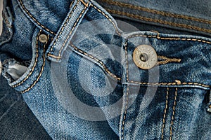 Close-up of a pair of jeans with the word