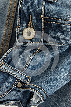 Close-up of a pair of jeans with the word