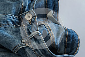 Close-up of a pair of jeans with the word