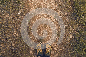 Close-up of a pair of shoes on a dirt road