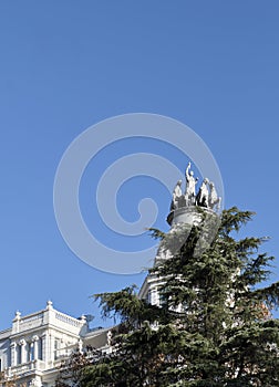 Close-up of the Palacio de Ramon Pla Monje or Edificio de Seguros La Aurora in the Paseo de Recoletos with statue on the dome. photo