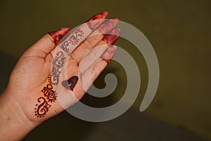 The palm of a girl with Mehandi design
