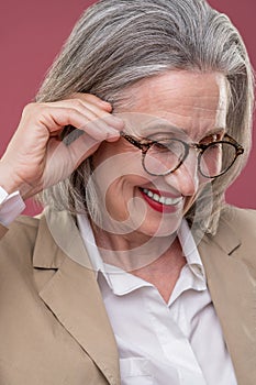 Close up of a pampered mature woman in eyeglasses