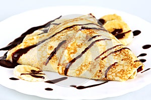 Close-up pancakes with bananas and chocolate