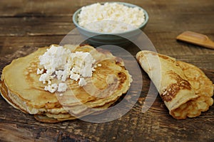 Close-up pancakes with cottage cheese on wooden rustic background