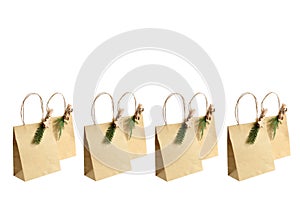 Close up paper brown bag with wooden clip with green leaf of pines and branche of small red fruit in white background isolated and