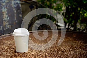 Close up paper cup on the rust table