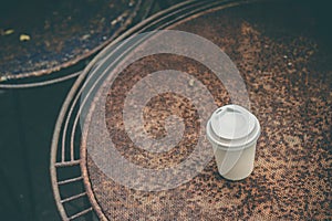 Close up paper cup on the rusty table