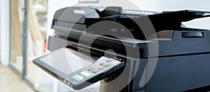 Close up paper sheets on the printer in office room