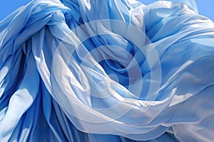 close-up of parachute fabric unfurling against blue sky