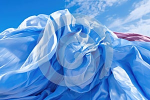 close-up of parachute fabric unfurling against blue sky