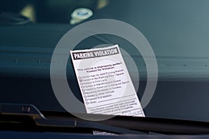 Close-up of parking ticket on car`s windshield